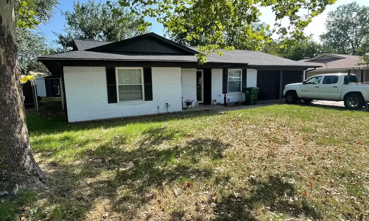 Professional roofing crew working on a residential roof in Scottdale